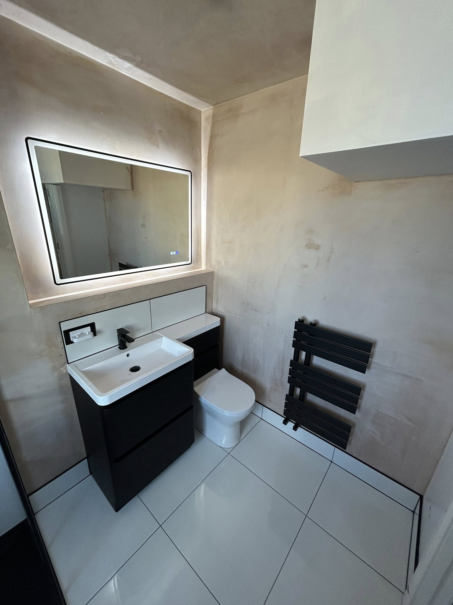 Luxe grey cloakroom with round backlit mirror